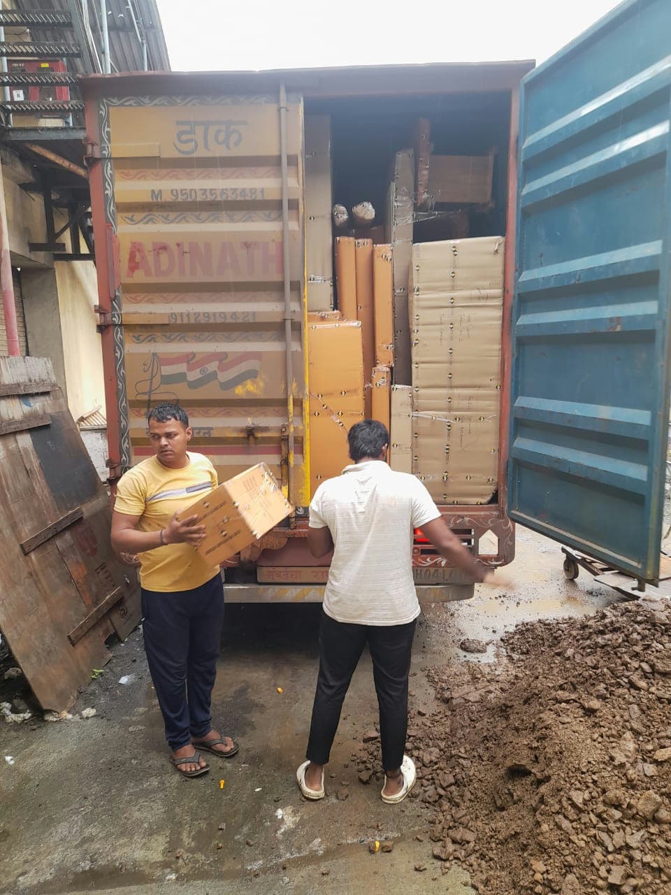 Our expert moving team carefully loading packed boxes into a secure transport vehicle.